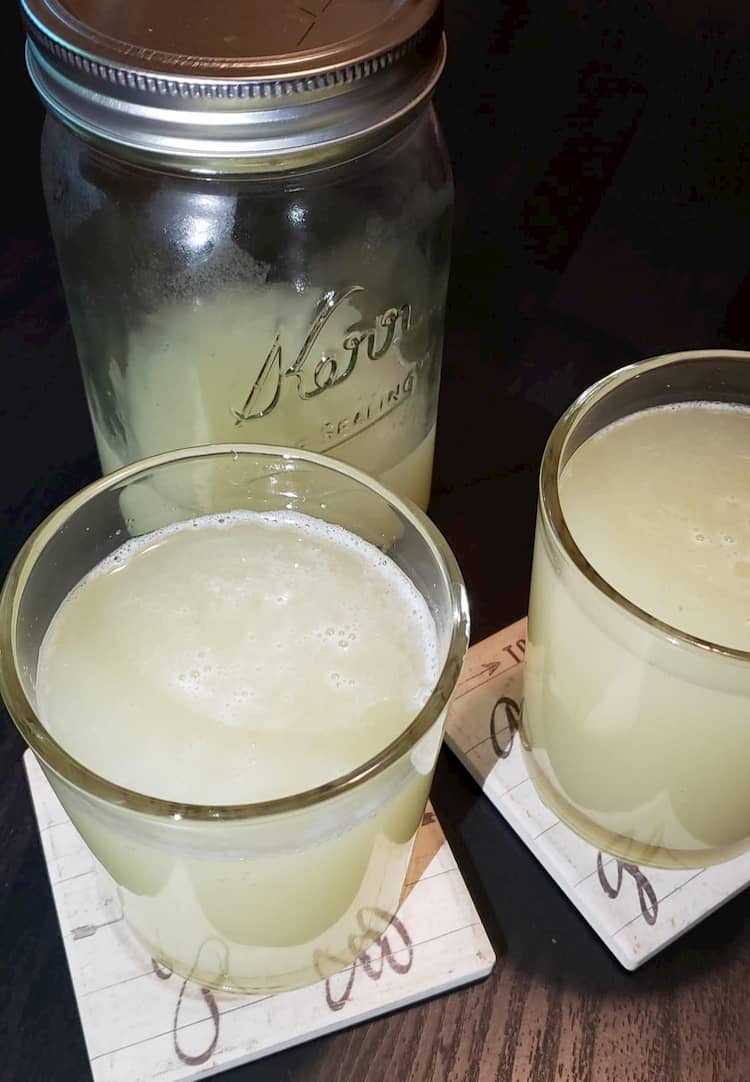 Homemade fermented ginger beer in mason jar and glasses