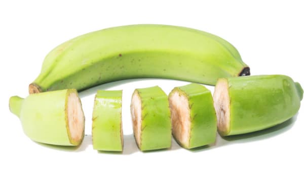 Green banana cut in chunks for soup (with skin on)